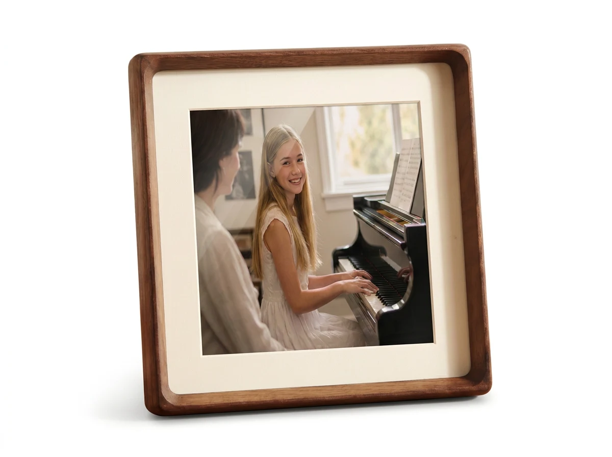 MYKEEPO walnut picture frame displaying a photo of a blonde teenager smiling while playing the piano with her teacher